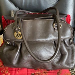 Create great energy carrying a  Donald Pliner bag